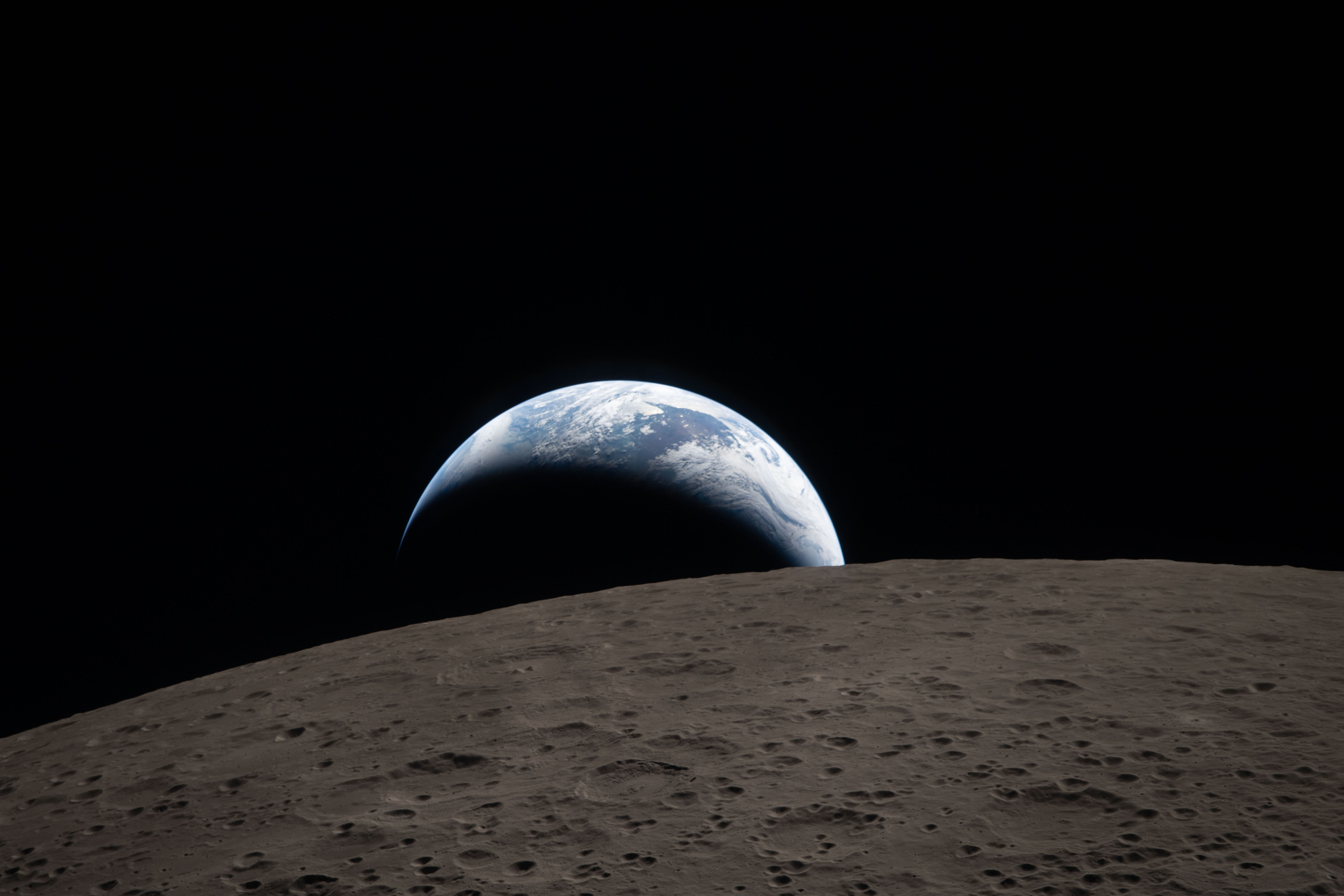 Earth rising above the Moon